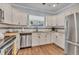 Modern kitchen featuring stainless steel appliances and white cabinets at 305 Pameto Rd, Nokomis, FL 34275