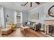 Living room with hardwood floors, fireplace, and a ceiling fan at 305 Pameto Rd, Nokomis, FL 34275