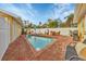 Brick patio with inviting pool and lounge chairs at 305 Pameto Rd, Nokomis, FL 34275