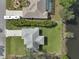 Aerial view of the house, showing the roof, long drive, neighboring properties and the pond to the rear at 3151 Johannesberg Rd, North Port, FL 34288