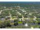 Aerial view of a home in a peaceful, wooded neighborhood with nearby canal and lush surroundings at 3151 Johannesberg Rd, North Port, FL 34288