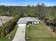 Charming home featuring a long driveway, attached garage, manicured lawn, and a tranquil water view at 3151 Johannesberg Rd, North Port, FL 34288