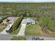 An aerial view of the house with a long drive, large yard and backing onto a pond and extensive woodland at 3151 Johannesberg Rd, North Port, FL 34288