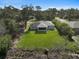 An aerial view of the backyard showcases a well-maintained lawn and screened-in lanai that backs up to a canal at 3151 Johannesberg Rd, North Port, FL 34288