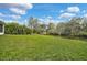 The expansive lawn and meticulous landscaping of the backyard offer a private retreat with water views at 3151 Johannesberg Rd, North Port, FL 34288