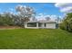 A well-maintained lawn surrounds the home, with a screened-in lanai offering serene backyard views at 3151 Johannesberg Rd, North Port, FL 34288