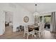 Dining area with hardwood floors, a chandelier, and access to outdoor living space at 3151 Johannesberg Rd, North Port, FL 34288