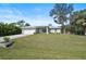Charming single-story home features a manicured front lawn and attached two car garage, set under a sunny sky at 3151 Johannesberg Rd, North Port, FL 34288