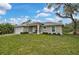Well maintained exterior elevation featuring a manicured lawn and an attached two car garage at 3151 Johannesberg Rd, North Port, FL 34288