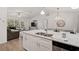 Open kitchen featuring stainless appliances, a large island with a double sink and bar stool seating at 3151 Johannesberg Rd, North Port, FL 34288