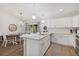 A bright kitchen with stainless steel appliances, a center island with a marble countertop, and tile backsplash at 3151 Johannesberg Rd, North Port, FL 34288