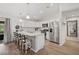 Bright kitchen with stainless steel appliances, a large island with bar stool seating, and modern light fixtures at 3151 Johannesberg Rd, North Port, FL 34288