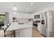 Bright kitchen with stainless steel appliances, a large island with bar stool seating, and modern light fixtures at 3151 Johannesberg Rd, North Port, FL 34288