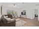 Spacious living room featuring a leather sofa, hardwood floors, and natural light at 3151 Johannesberg Rd, North Port, FL 34288