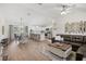 Open-concept living space with hardwood floors, stainless steel appliances, and a large leather sofa at 3151 Johannesberg Rd, North Port, FL 34288
