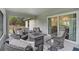 A delightful covered patio space features cozy seating and blends the tranquility of the indoors with the outdoors at 3151 Johannesberg Rd, North Port, FL 34288