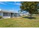 View of the home's backyard, featuring a screened porch at 3701 39Th W St, Bradenton, FL 34205
