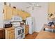 Kitchen with white appliances and wood cabinets at 3701 39Th W St, Bradenton, FL 34205