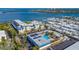 Aerial view of a coastal community, highlighting a building with a pool and parking at 3810 Gulf Of Mexico Dr # F302, Longboat Key, FL 34228