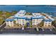 Aerial view of a building with parking and waterfront access at 3810 Gulf Of Mexico Dr # F302, Longboat Key, FL 34228