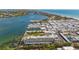 Aerial view of waterfront community with buildings, pool, and boat docks at 3810 Gulf Of Mexico Dr # F302, Longboat Key, FL 34228