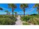 Beach access walkway with lush landscaping at 3810 Gulf Of Mexico Dr # F302, Longboat Key, FL 34228