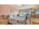 Bright bedroom with water views and twin beds at 3810 Gulf Of Mexico Dr # F302, Longboat Key, FL 34228