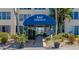 Condo building entrance with awning, walkway, and landscaping at 3810 Gulf Of Mexico Dr # F302, Longboat Key, FL 34228