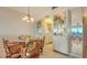 Small dining area with glass-top table and wicker chairs at 3810 Gulf Of Mexico Dr # F302, Longboat Key, FL 34228