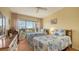 Bright guest bedroom with twin beds, water view, and built-in desk at 3810 Gulf Of Mexico Dr # F302, Longboat Key, FL 34228