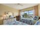 Well-lit guest bedroom featuring twin beds and stunning water views at 3810 Gulf Of Mexico Dr # F302, Longboat Key, FL 34228