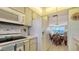 Kitchen with white appliances, view of dining area and waterfront at 3810 Gulf Of Mexico Dr # F302, Longboat Key, FL 34228