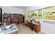 Community library with bookshelves and work area at 3810 Gulf Of Mexico Dr # F302, Longboat Key, FL 34228