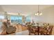 Living room with water views, comfortable seating, and hardwood floors at 3810 Gulf Of Mexico Dr # F302, Longboat Key, FL 34228