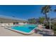 Relaxing community pool with surrounding patio and lounge chairs at 3810 Gulf Of Mexico Dr # F302, Longboat Key, FL 34228