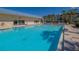 Inviting community pool with lounge chairs and patio area at 3810 Gulf Of Mexico Dr # F302, Longboat Key, FL 34228