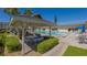 Community pool with patio tables and shade pergola at 3810 Gulf Of Mexico Dr # F302, Longboat Key, FL 34228