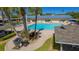 Community pool, BBQ grills and relaxing patio area at 3810 Gulf Of Mexico Dr # F302, Longboat Key, FL 34228