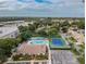 Aerial view showing community pool, tennis courts, and building exteriors at 425 30Th W Ave # C212, Bradenton, FL 34205