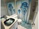 Clean bathroom with updated vanity and jellyfish shower curtain at 425 30Th W Ave # C212, Bradenton, FL 34205