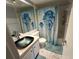 Clean bathroom with updated vanity and jellyfish shower curtain at 425 30Th W Ave # C212, Bradenton, FL 34205