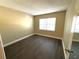 Bright bedroom with dark gray laminate flooring and window at 425 30Th W Ave # C212, Bradenton, FL 34205