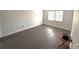 Spacious bedroom with dark gray laminate flooring and window coverings at 425 30Th W Ave # C212, Bradenton, FL 34205