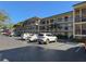 Two story condo building with parking lot and landscaping at 425 30Th W Ave # C212, Bradenton, FL 34205