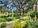 Landscaped walkway along a lake with a bench and lush greenery at 425 30Th W Ave # C212, Bradenton, FL 34205
