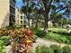 Landscaped area with walkway next to a lake and building at 425 30Th W Ave # C212, Bradenton, FL 34205