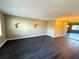 Spacious living room with dark hardwood floors and updated lighting fixtures at 425 30Th W Ave # C212, Bradenton, FL 34205