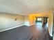 Open living room with dark hardwood floors and mirrored wall at 425 30Th W Ave # C212, Bradenton, FL 34205