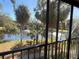 Scenic pond view from condo balcony with lush tropical foliage at 425 30Th W Ave # C212, Bradenton, FL 34205