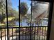 Peaceful pond view from condo with palm trees and lush landscaping at 425 30Th W Ave # C212, Bradenton, FL 34205